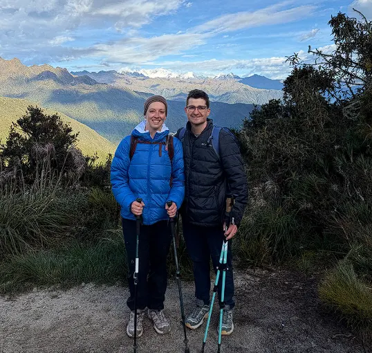 Couple equipped with trekking poles and warm layers on the Inca Trail