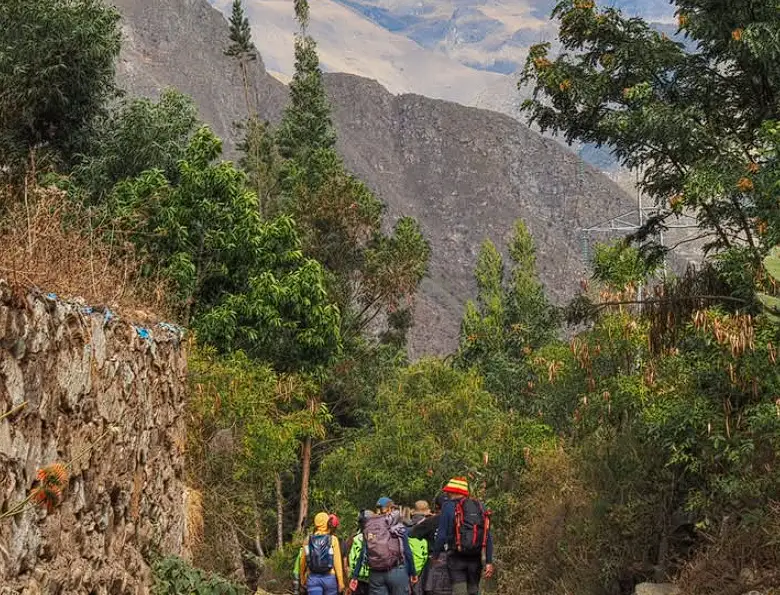 Tourists walking along the ancient Inca Trail path in Peru
